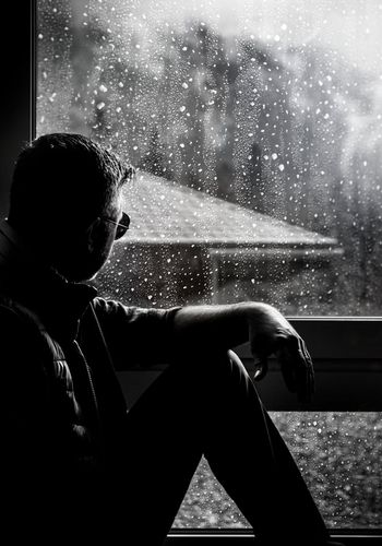 Silhouette of a man looking out, symbolizing introspection and peace.